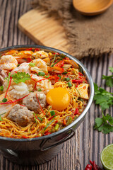 Thai food; instant noodles spicy boil with seafood and pork in hot pot