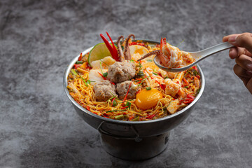 Thai food; instant noodles spicy boil with seafood and pork in hot pot
