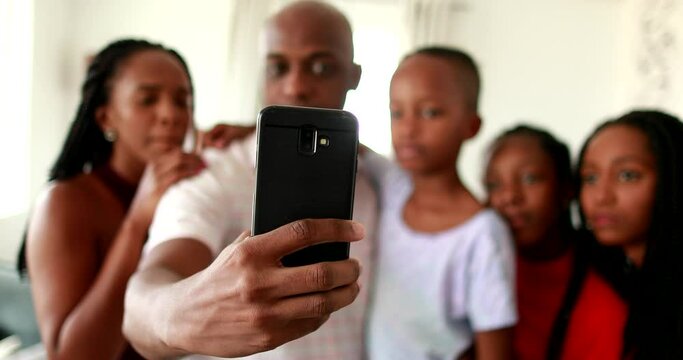 Black African family watching  smartphone screen together