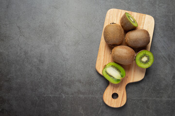 Fresh kiwi, cut into half, put on wooden cutting board