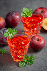 glasses of plum put on dark floor