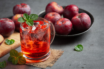 a glass of plum put on dark floor