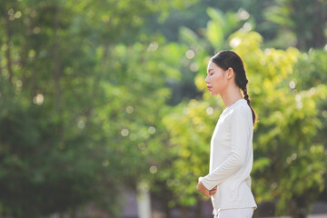 woman in white outfit meditating in nature