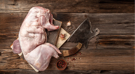 Rabbit meat. A whole carcass of a young, fresh rabbit ready for cooking, menu recipe place for text, top view © Надія Коваль