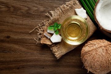 a glass of coconut oil put on wooden dark floor