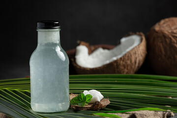 a bottle of coconut water put on dark background