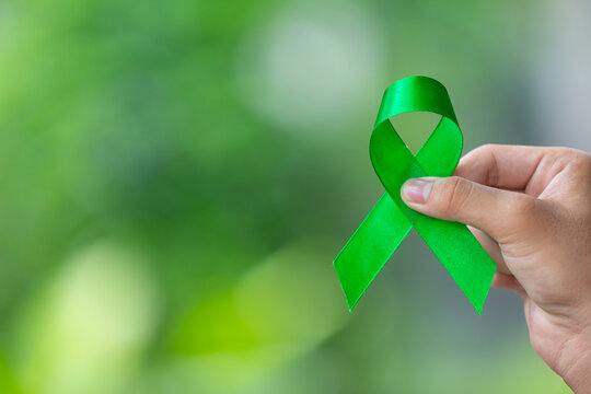 World Mental Health Day;hand holding green ribbon