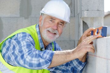 senior land surveyor happily smiling at camera