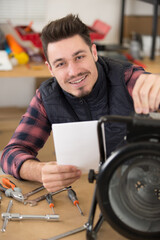 a portrait of young handyman at diy workshop