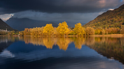 autumn landscape with trees reflecting in the lake
