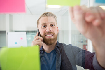 man using adhesive notes in windows