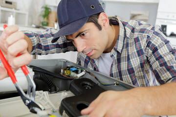 a handyman repairing washing machine