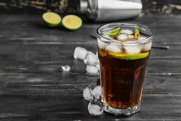 Glass of tasty Cuba Libre cocktail on table