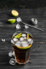 Glass of tasty Cuba Libre cocktail on table