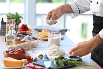 Mature chef cooking in kitchen, closeup
