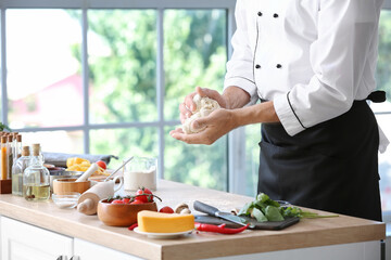 Obraz na płótnie Canvas Mature chef cooking in kitchen