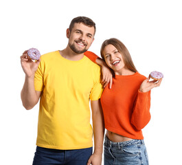 Young couple with sweet donuts on white background