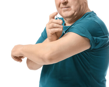 Senior Diabetic Man Giving Himself Insulin Injection On White Background