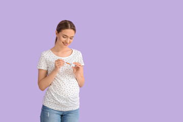 Pregnant diabetic woman with insulin syringe and ampule on color background