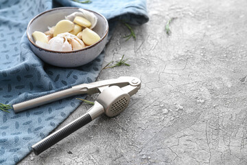 Garlic press on grunge background