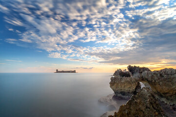 Obraz premium Long exposure landscape of the Maiden's Castle (Turkish: Kizkalesi). The castle was established to prevent attacks from the Sea. It contains remains of a church.