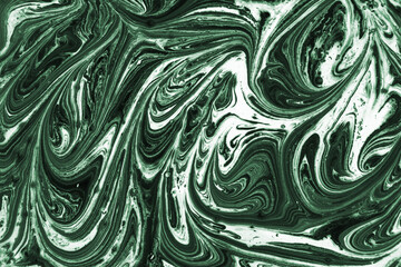 Mix of a white and green paint, closeup. Abstract marble effect