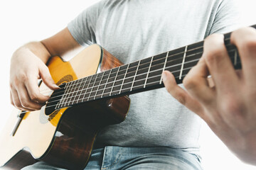 Fototapeta na wymiar Close-up of guitarist hand playing on classical guitar
