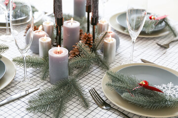 Beautiful table setting with Christmas decorations in living room, closeup