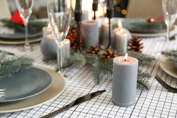 Beautiful table setting with Christmas decorations in living room, closeup