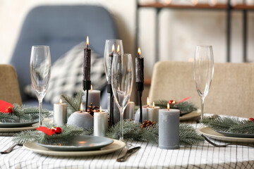 Beautiful table setting with Christmas decorations in living room