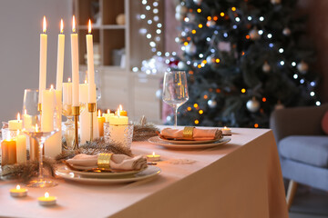 Beautiful table setting with Christmas decorations in living room