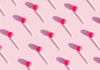geometric pattern with chupachups on a pink background. bright pattern. fun and sweets