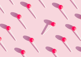 geometric pattern with chupachups on a pink background. contrast to the crowd, be different