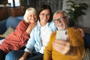 Happy granddaughter and grandparents chatting on video call