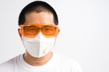 Asian man wearing safety glasses with face mask