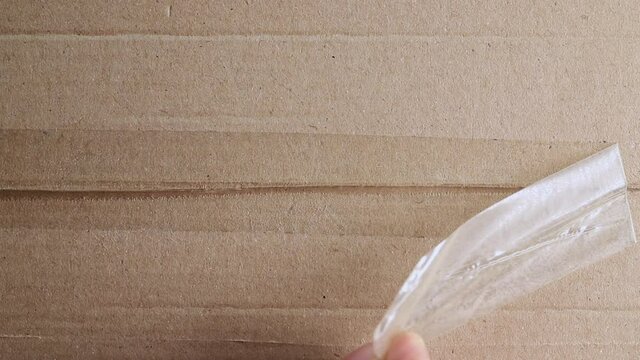 Opening cardboard box close up