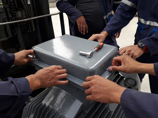 Technician open box of Electric motor for inspection and insulation test wireding, Corrective maintenan concept