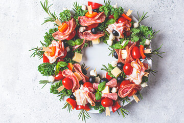 Christmas wreath of festive appetizer. Canapes with cheese, vegetables and ham. Christmas food...