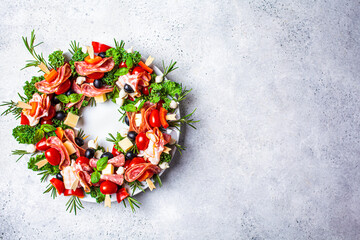 Christmas wreath of festive appetizer. Canapes with cheese, vegetables and ham, copy space....