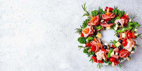 Christmas wreath of festive appetizer. Canapes with cheese, vegetables and ham, copy space....