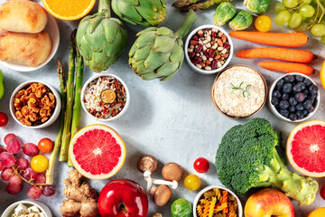 Vegetarian food background with a place for text, a flat lay, shot from the top. Fruit, vegetables and cheese, top-down view