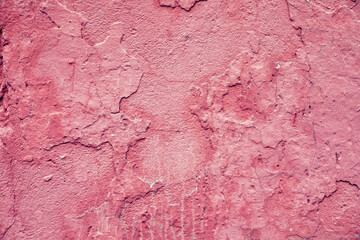 Weathered and cracked pink wall texture as background