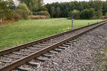 Fototapeta premium Diagonal railroad track through countryside landscape