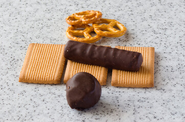 Rectangular shortbread cookies and chocolates on a light marble top.