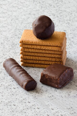 Rectangular shortbread cookies and chocolates on a light marble top.