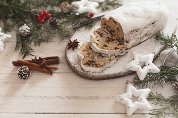 Christmas stollen on wooden background. Traditional Christmas festive pastry dessert. Stollen for Christmas.