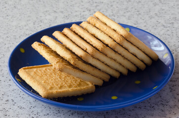 Delicious biscuits on a blue saucer and marble top.