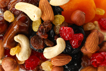 Nuts and dried fruits on whole background, close up