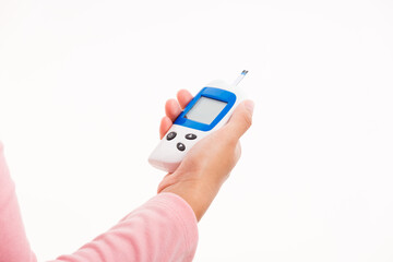 Closeup hand woman measuring glucose test level checking on finger by glucometer she monitor and control high blood sugar diabetes and glycemic health care medical concept isolated on white background