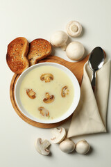 Concept of tasty lunch with bowl of mushroom soup on white background